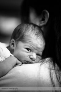 Newborn Baby Snuggling with Mom